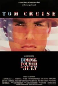 Poster for Born on the Fourth of July featuring Tom Cruise’s face overlaid with the American flag. The tagline at the top reads, “A true story of innocence lost and courage found.” The film’s title and Cruise’s name are stylized with stars and stripes, reinforcing the themes of patriotism and personal struggle.