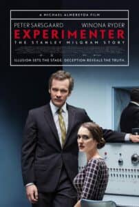 Poster for Experimenter, featuring Peter Sarsgaard as Stanley Milgram standing confidently in a grey suit and tie, and Winona Ryder seated beside an electric shock generator panel, referencing the famous obedience experiments. The tagline reads: “Illusion sets the stage. Deception reveals the truth.”
