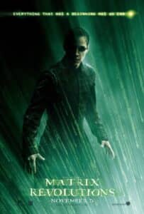 Poster for The Matrix Revolutions featuring Neo (Keanu Reeves) standing alone in a storm of cascading green digital code. His black outfit and sunglasses are bathed in eerie green light, with the tagline “Everything that has a beginning has an end” glowing above him in a typewritten digital font. The film title and release date “November 5” appear at the bottom.