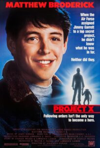 Poster for Project X featuring a large smiling portrait of Matthew Broderick. On the right side, text reads, “When the Air Force assigned Jimmy Garrett to a top secret project, he didn’t know what he was in for. Neither did they.” Below, the title Project X is in bold red, with the tagline: “Following orders isn’t the only way to become a hero.” A glowing silhouette at the bottom shows a man in uniform holding the hand of a chimpanzee, suggesting a partnership central to the film.