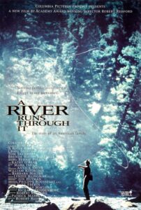 Poster for A River Runs Through It, featuring a silhouetted fly fisherman casting his line in a shimmering forest stream. The soft, blue-toned lighting and tagline—“Nothing perfect lasts forever. Except in our memories.”—evoke nostalgia and the film’s themes of family, nature, and reflection.