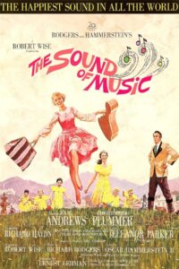 A joyful woman in a pink dress dances across a mountain meadow with a guitar case in one hand and a striped bag in the other. She’s surrounded by smiling children in yellow dresses running through the grass. A stern man in a tan jacket stands off to the side with mountains and a city in the background. Above them, the title The Sound of Music swirls with colorful musical notes, and the tagline reads “The Happiest Sound in All the World.”