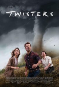 Three storm chasers — a woman, a man in a red plaid shirt, and a man in a white button-up — stare in awe and fear as a massive tornado barrels through a windswept field behind them. The storm looms large under a dark, churning sky. The title Twisters appears in bold white, jagged lettering above the tornado.