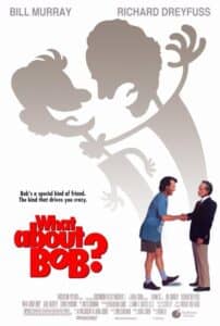 Poster for What About Bob? featuring cartoonish, oversized silhouettes of Bill Murray and Richard Dreyfuss playfully tugging at each other. Below the silhouettes, the live-action characters shake hands awkwardly—Bill Murray in casual blue athletic wear and Richard Dreyfuss in a suit. The tagline reads: “Bob’s a special kind of friend. The kind that drives you crazy.” The film’s title is displayed in bold red letters, emphasizing the comedic and offbeat tone.